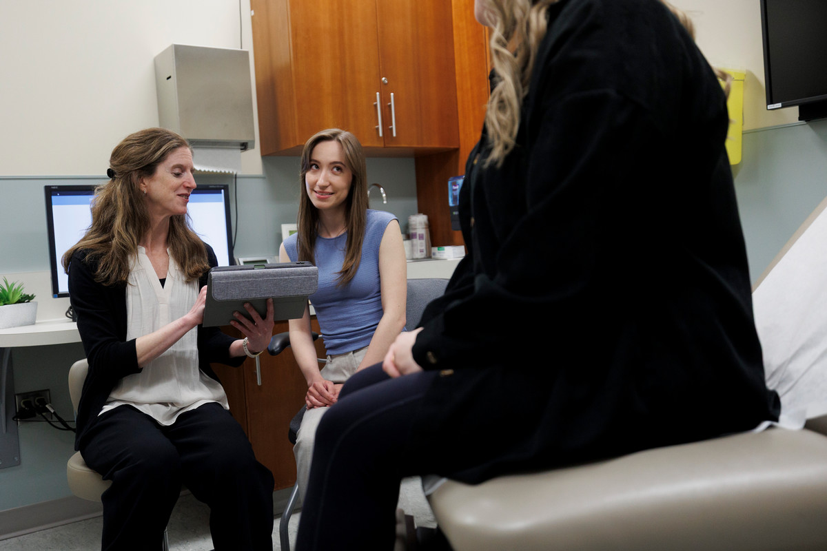 Student and a teacher examining a patient